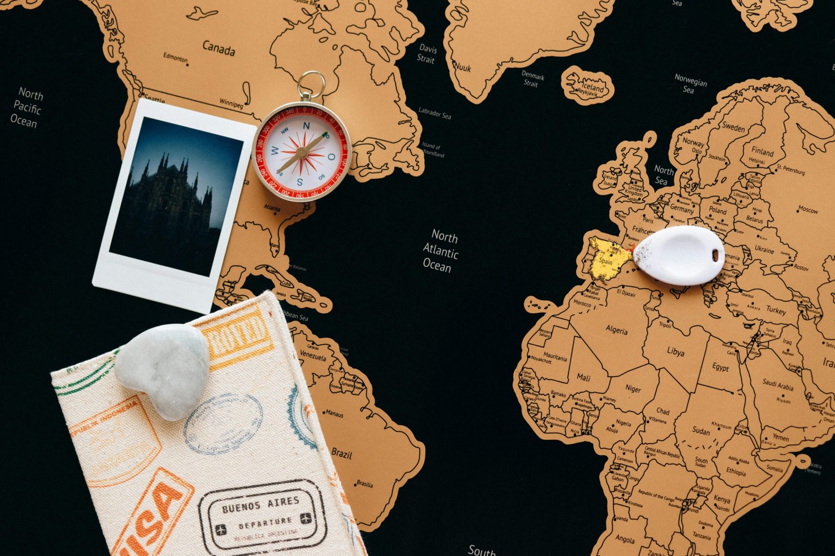 pexels-photo-7235907-7235907 Flat lay of travel items including a map, compass, and polaroid for adventure planning.